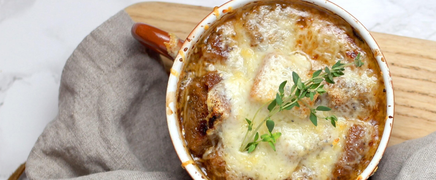 Soupe à l'oignon servie dans un bol chaud, avec des croûtons croustillants